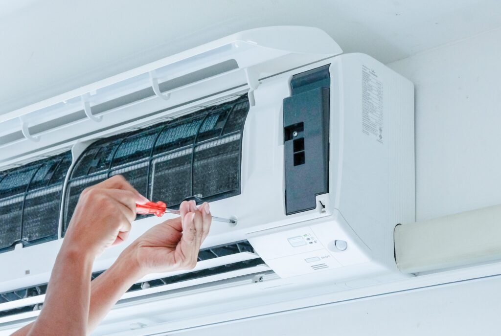 Technician installing a new air conditioning unit in a Fort Lauderdale home