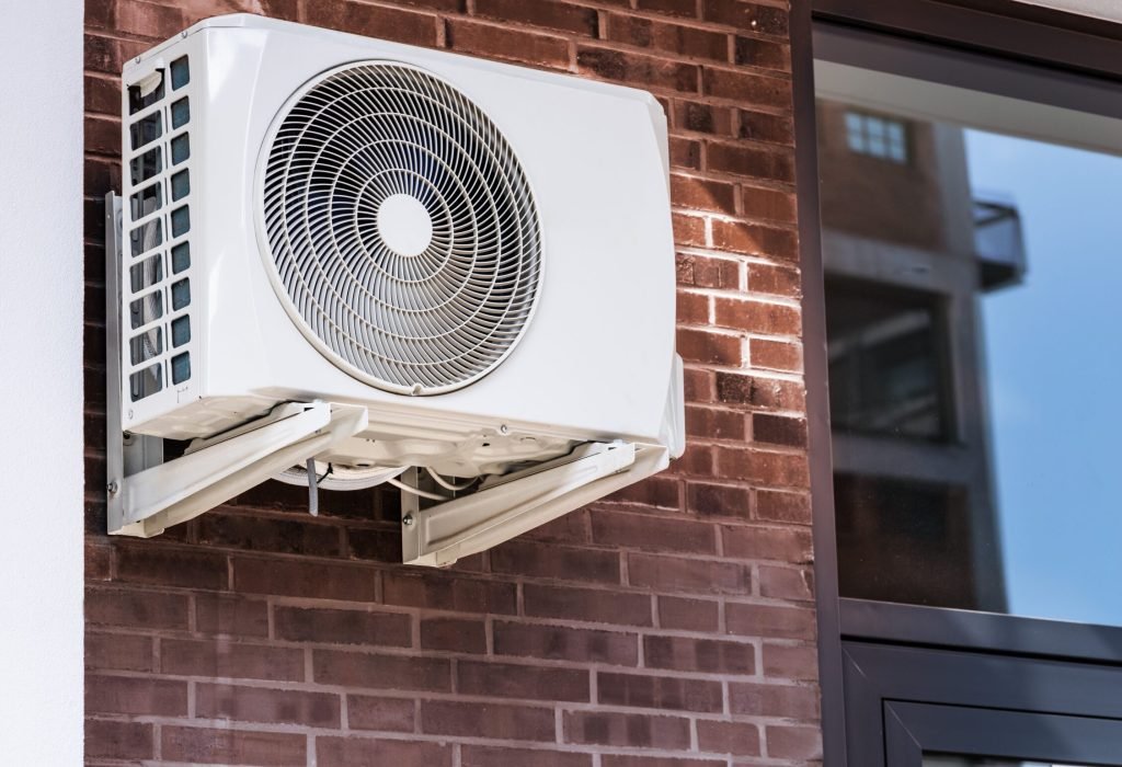 Air Conditioner And Heat Pump. Split HVAC System Unit ductless-ac-unit-outside-brick-wall
